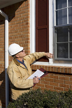 a building inspector inspecting home windows